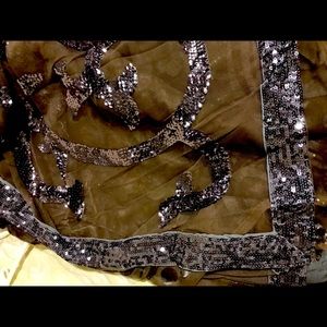 Olive green net Saree with sequins pattern.